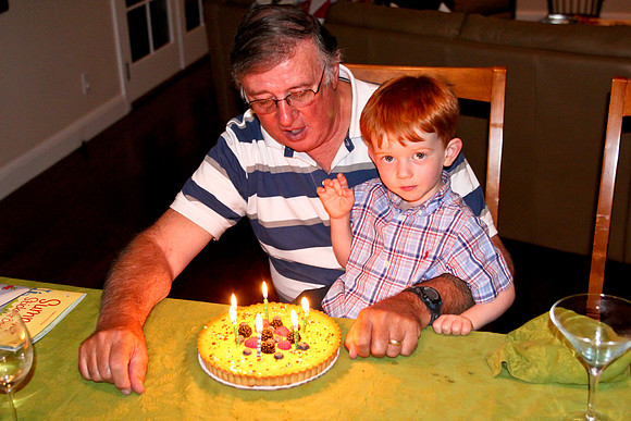 Jack helping Grandpa blow out his birthday cake